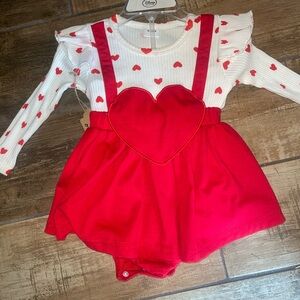 super cute red and white one piece with red hearts .